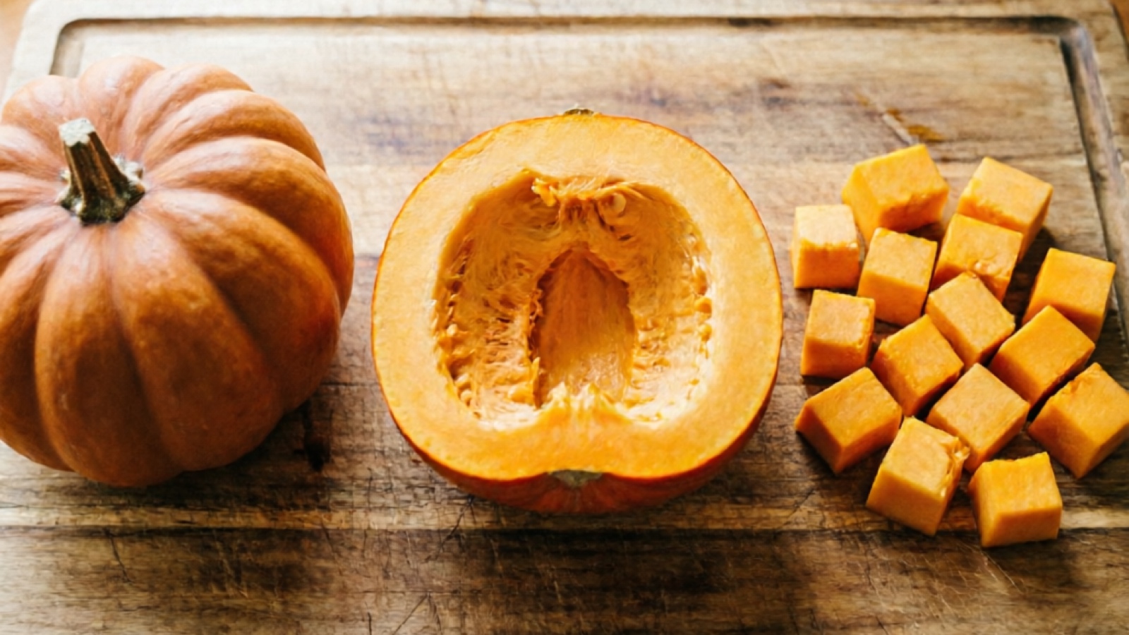 Step-by-step pumpkin preparation whole sugar pumpkin peeled and seeded cut into hamster-sized cubes on a clean cutting board